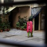 A pedestrian passes a apartment block where a domestic servant was allegedly tortured in New Delhi. Picture: Sajjad Hussain Source: AFP